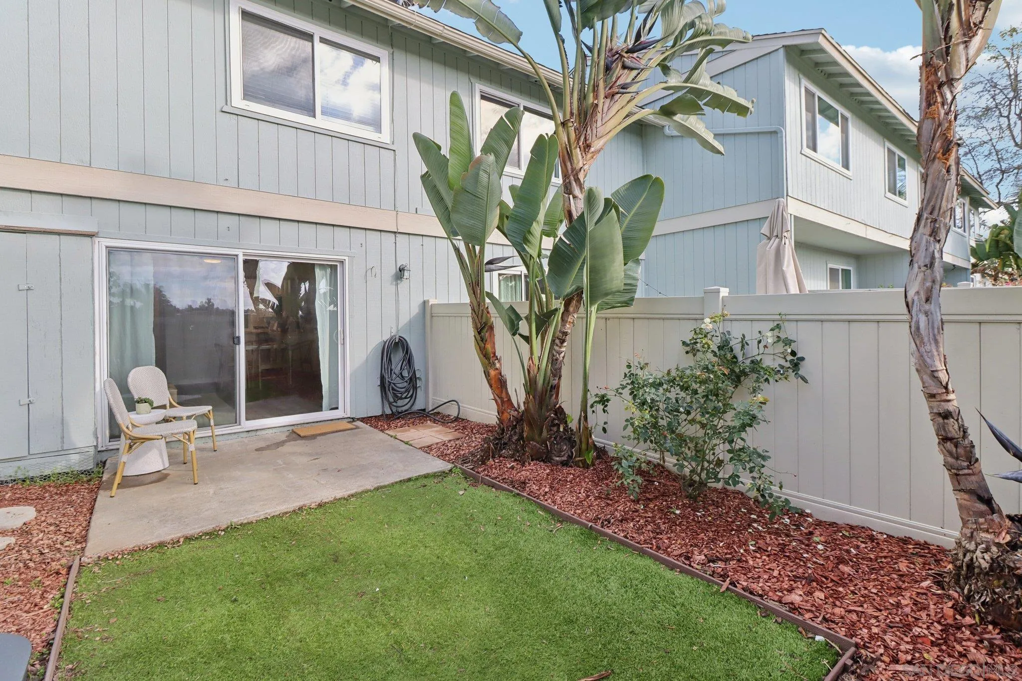 324 Countrywood Lane Encinitas, CA 92024 - Photo 23 of 42 a view of a chair and table in backyard of the house