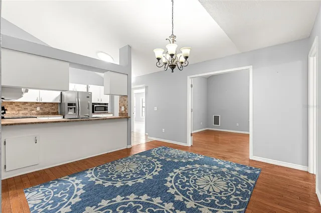 a view of kitchen with granite countertop cabinets and wooden floor
