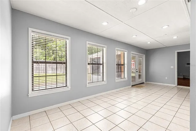 a view of empty room with wooden floor and fireplace