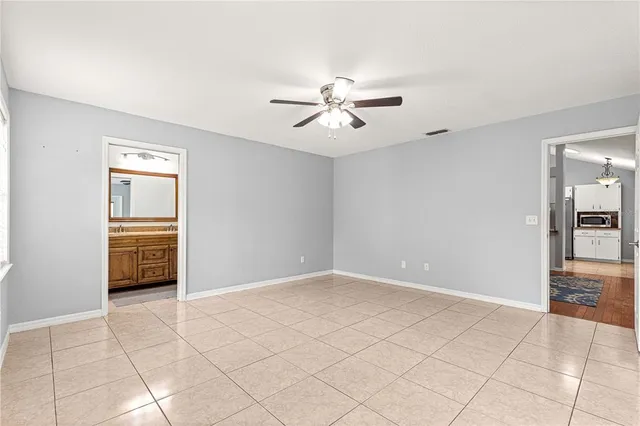 a bedroom with a large bed and a tv