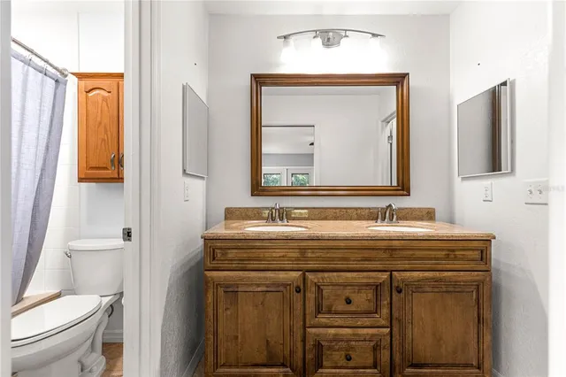 a white toilet sitting next to a shower curtain