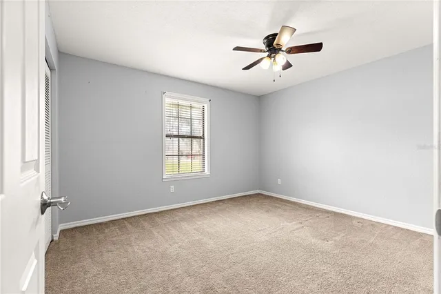 a living room with furniture and a ceiling fan