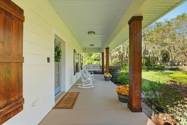 a living room with furniture a flat screen tv and a rug