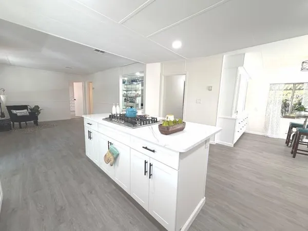 a kitchen with a sink and wooden floor