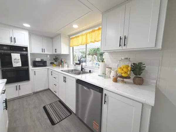 a kitchen with a sink cabinets and window