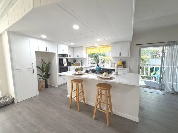 a kitchen with a table chairs refrigerator and cabinets
