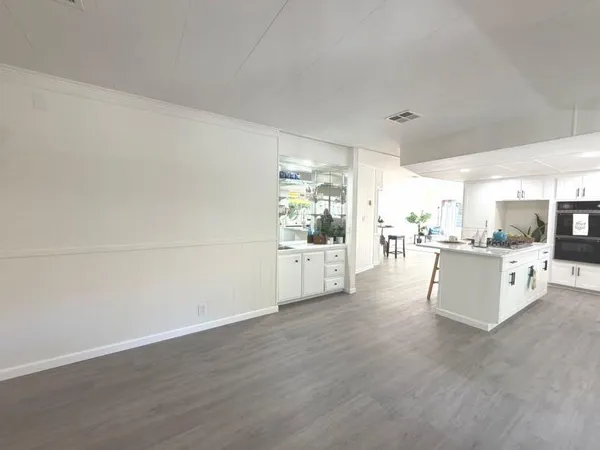 a large white kitchen with a large window