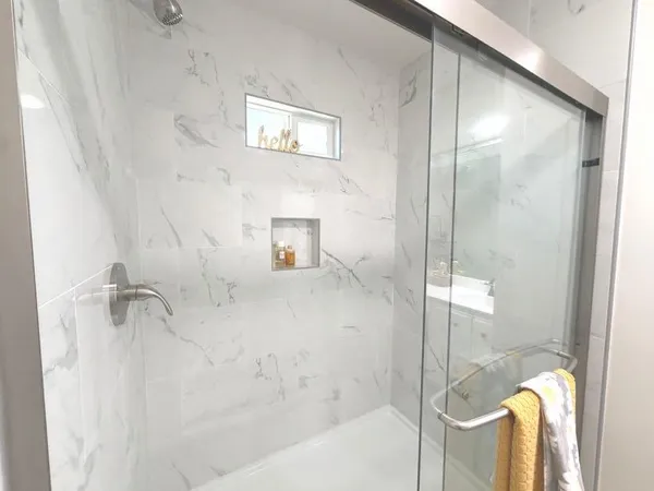 a bathroom with a bathtub and shower