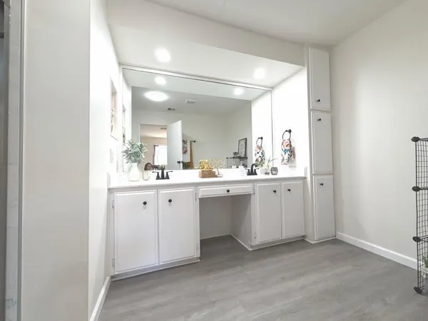 a bathroom with a double vanity sink and mirror