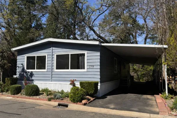 a view of a house with a small yard