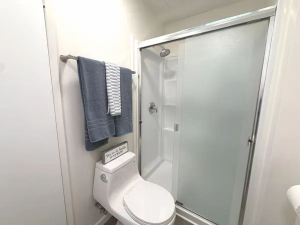 a white toilet sitting next to a bathroom sink