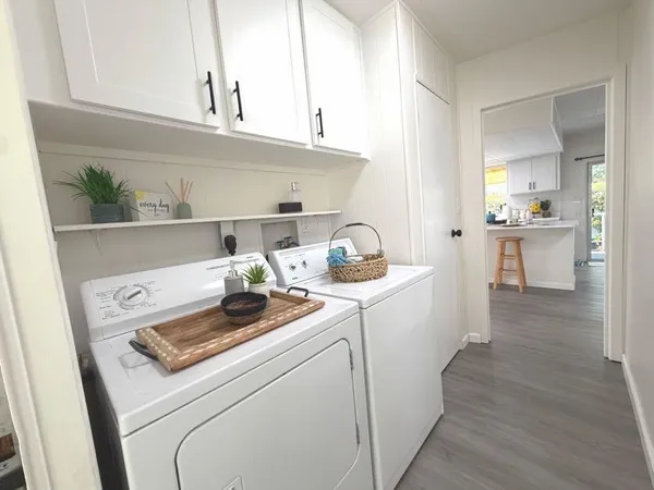 a kitchen with a stove and wooden floor