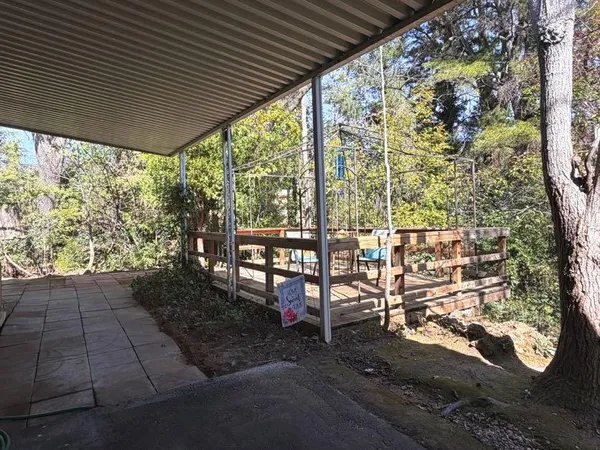 a view of a porch with furniture and garden