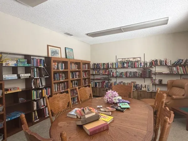 a living room with furniture and a book shelf