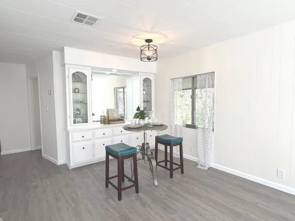 a view of a dining room with furniture and window