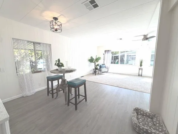 a view of a livingroom with furniture window and wooden floor