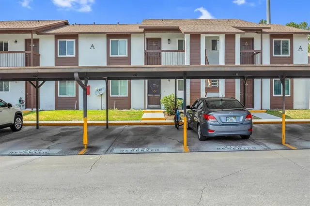 a view of a cars park in front of a building