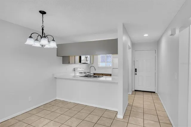 a kitchen with stainless steel appliances a refrigerator sink and microwave