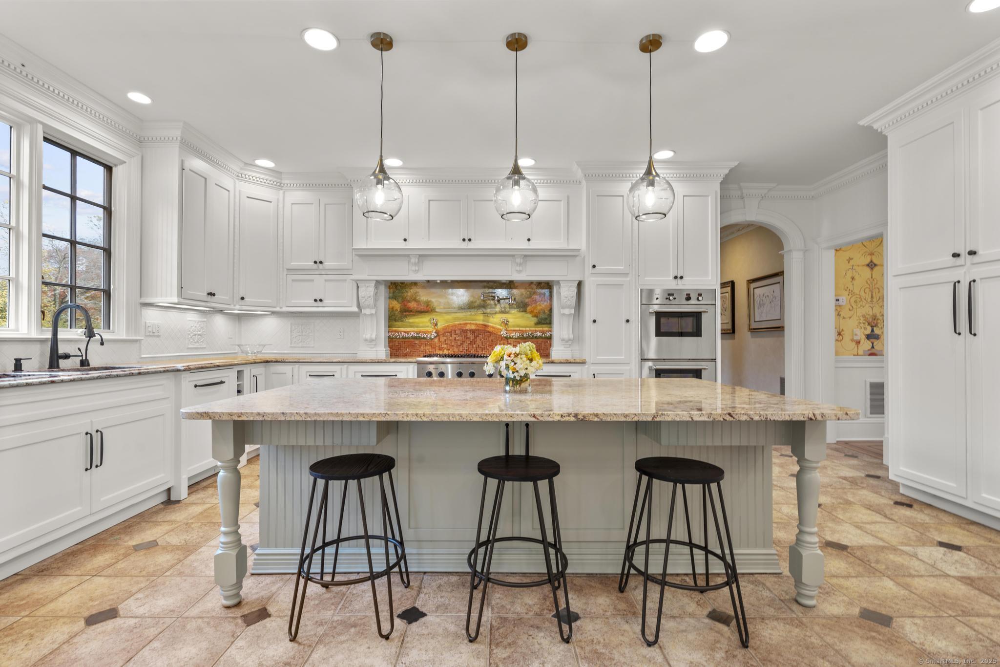 342 Midlock Road Fairfield, CT 06824 - Photo 12 of 40 a kitchen with stainless steel appliances kitchen island granite countertop a sink a stove a dining table and chairs