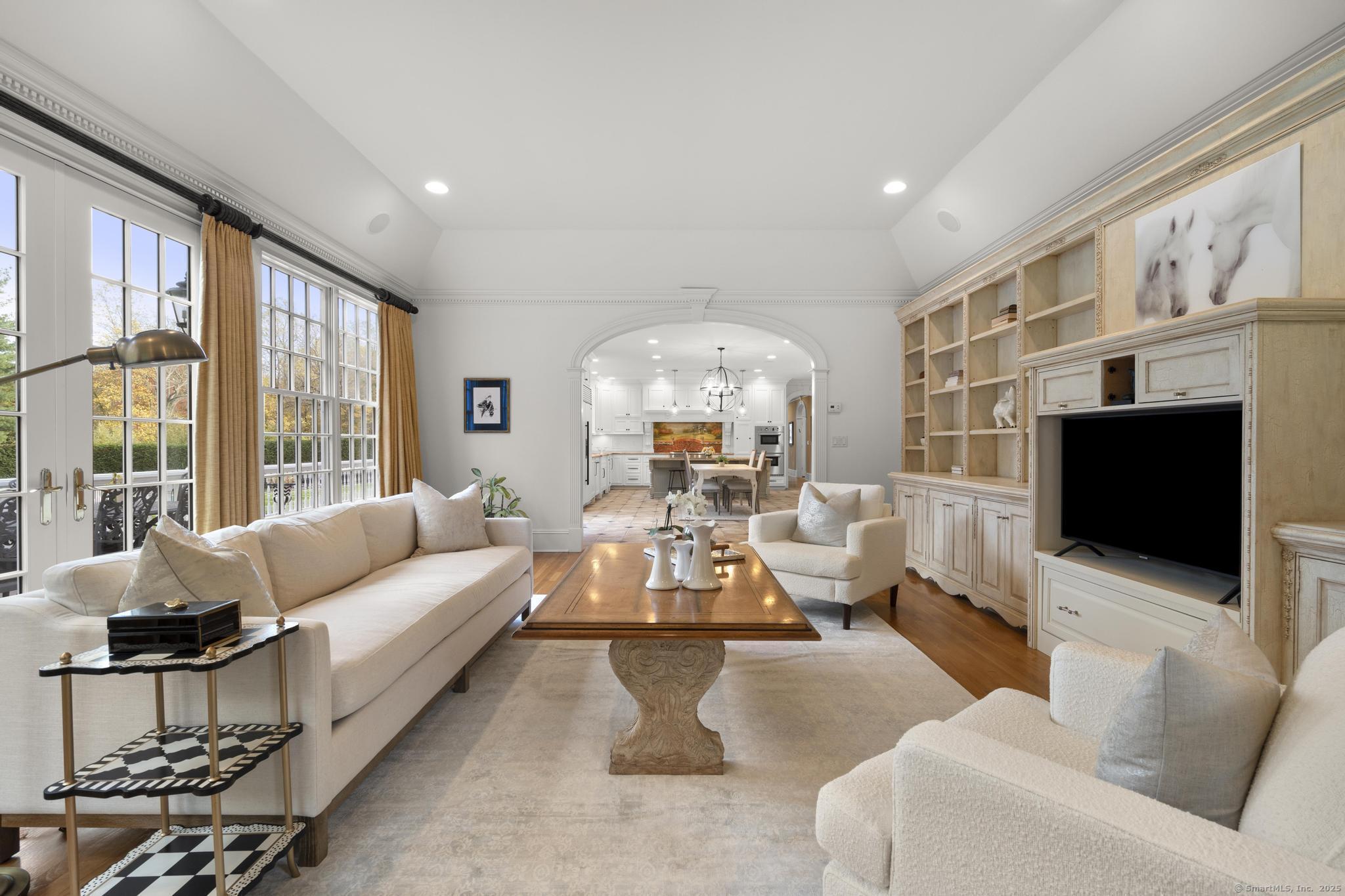 342 Midlock Road Fairfield, CT 06824 - Photo 15 of 40 a living room with fireplace furniture and a flat screen tv