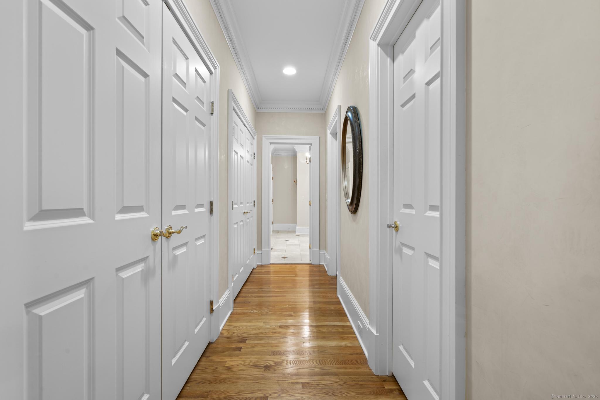 342 Midlock Road Fairfield, CT 06824 - Photo 19 of 40 a view of a hallway with wooden floor and staircase