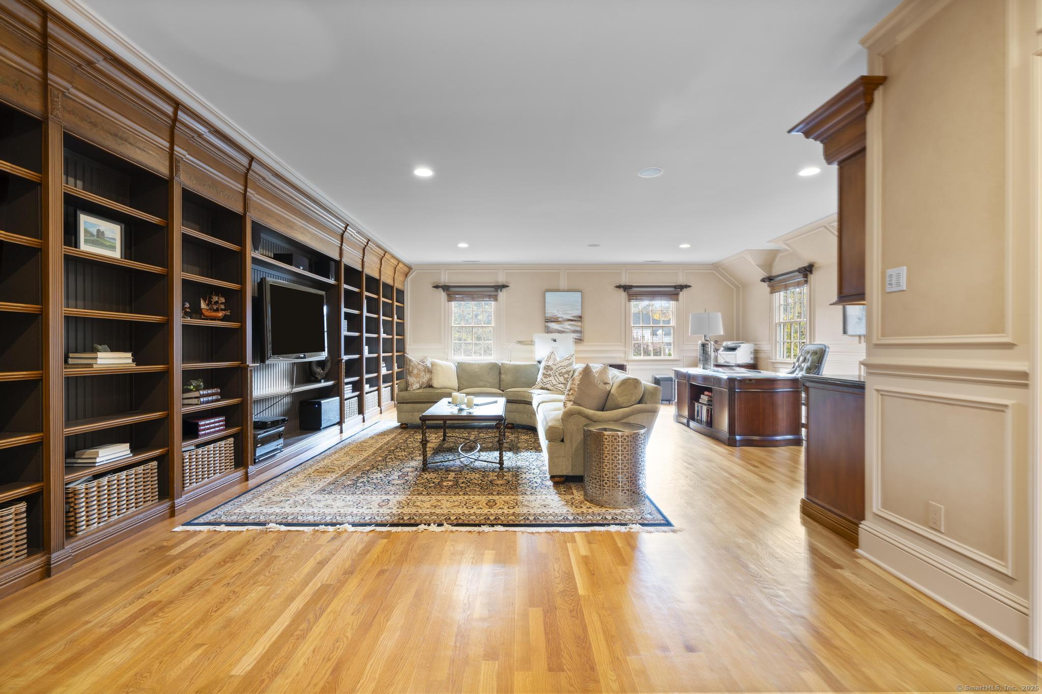 342 Midlock Road Fairfield, CT 06824 - Photo 22 of 40 a living room with furniture a rug and a flat screen tv