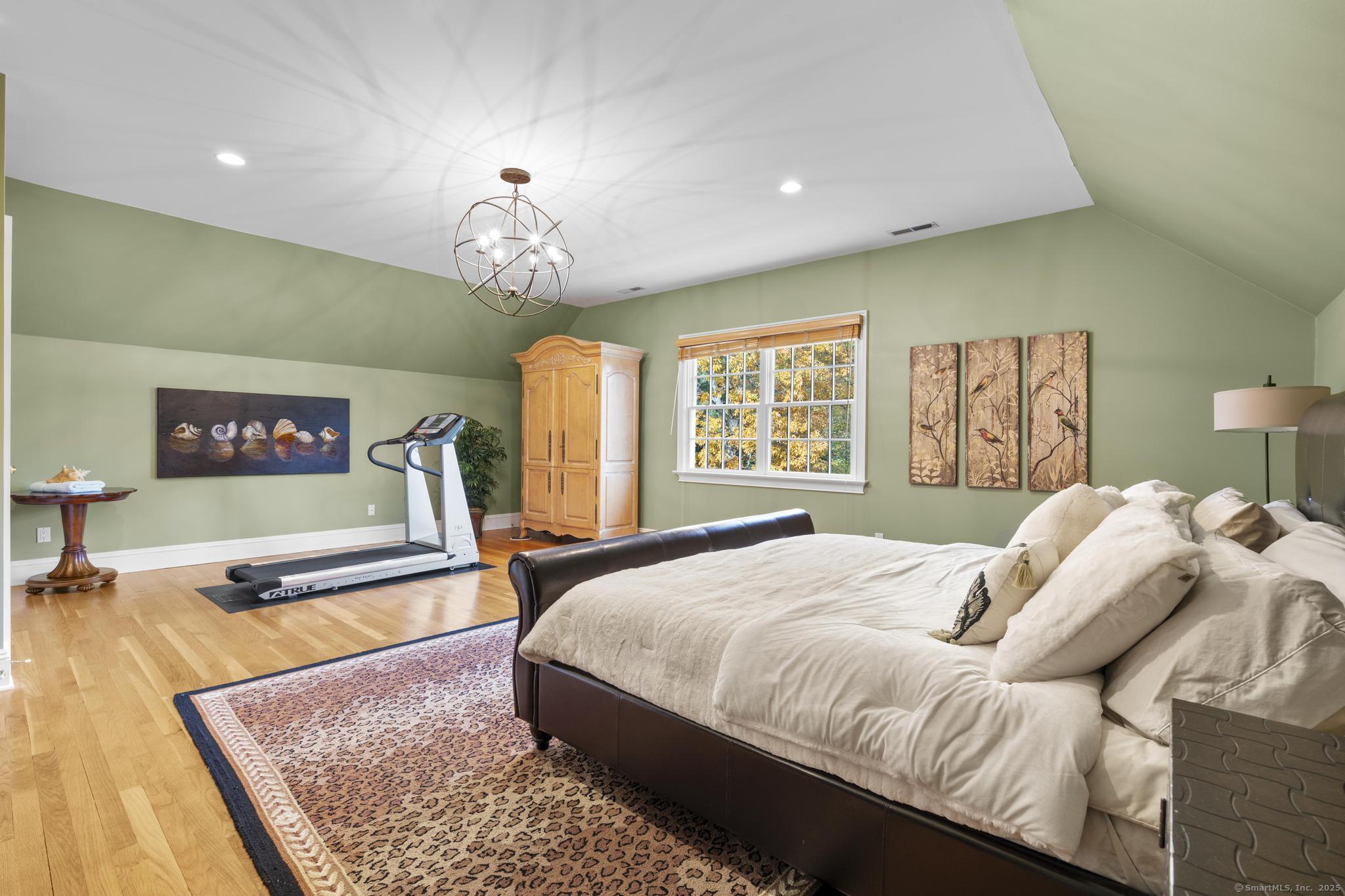 342 Midlock Road Fairfield, CT 06824 - Photo 24 of 40 a bedroom with a bed and a flat screen tv