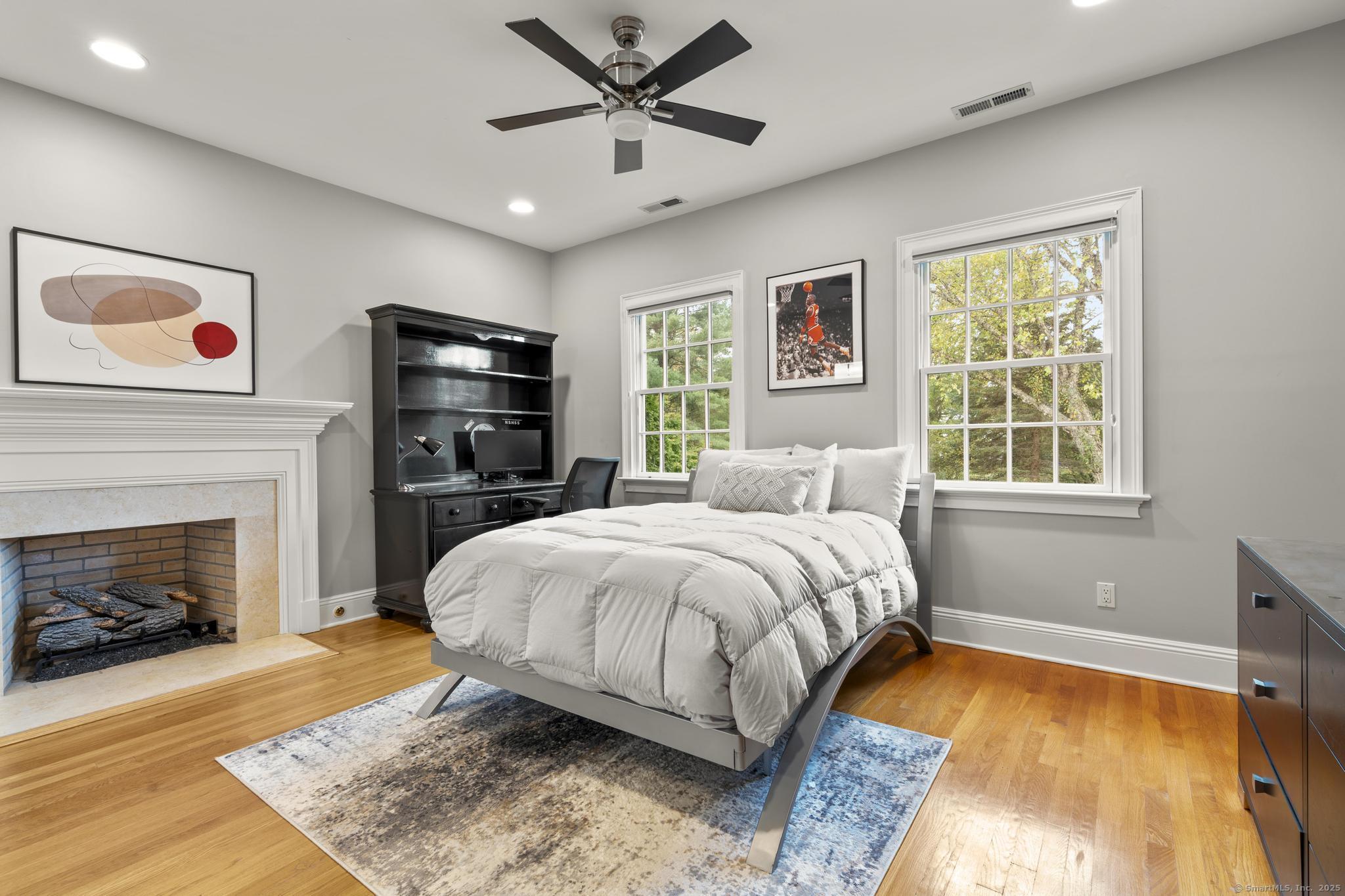 342 Midlock Road Fairfield, CT 06824 - Photo 26 of 40 a spacious bedroom with a bed and a fireplace