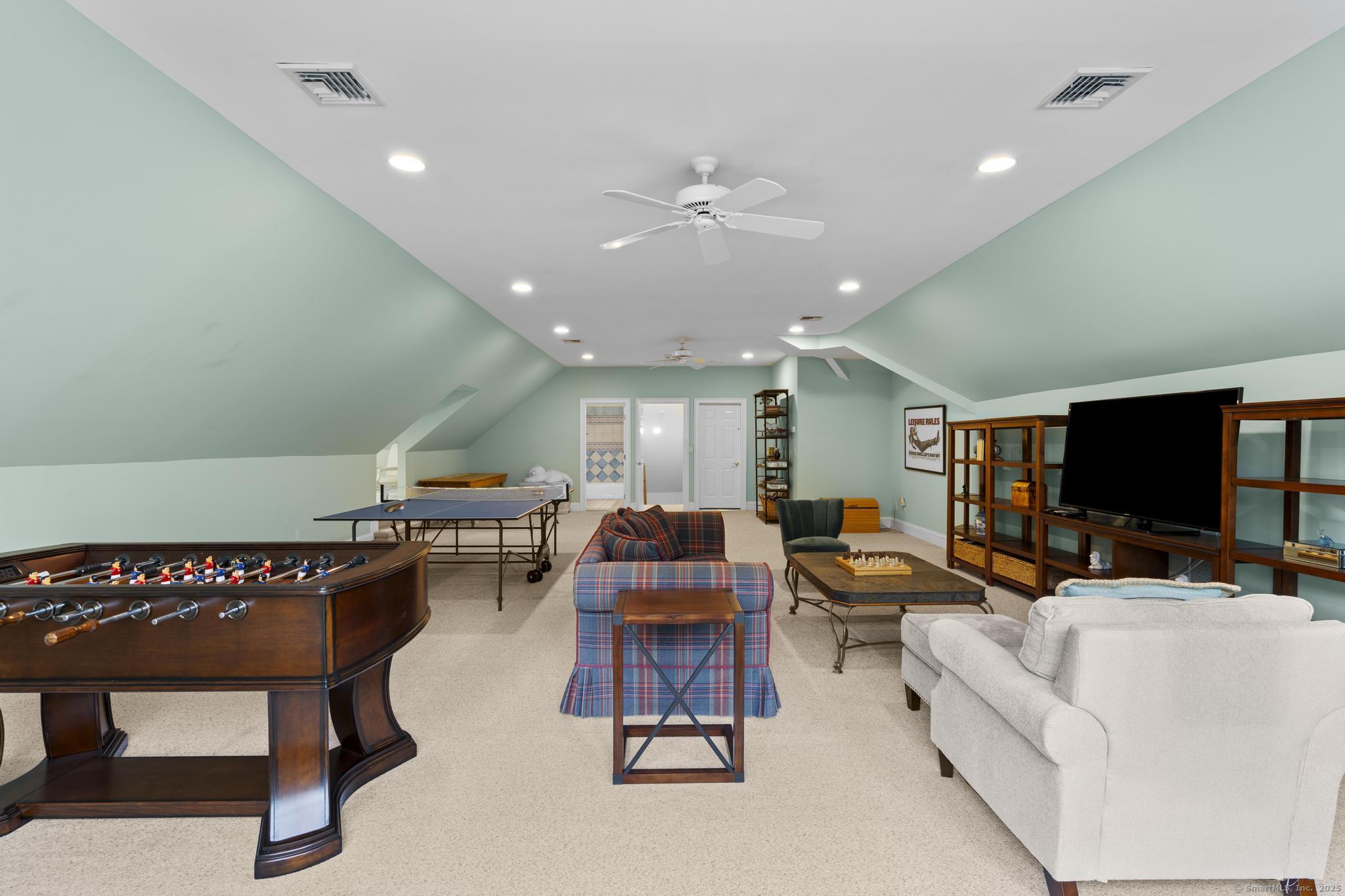 342 Midlock Road Fairfield, CT 06824 - Photo 33 of 40 a living room with furniture and a flat screen tv