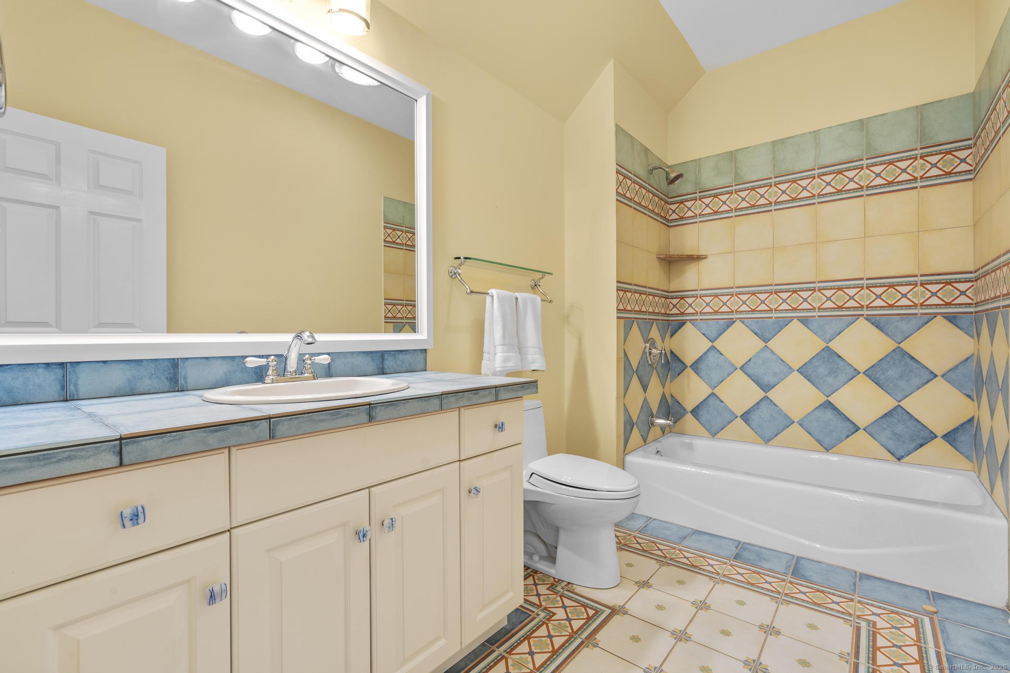 342 Midlock Road Fairfield, CT 06824 - Photo 34 of 40 a bathroom with a sink a toilet a mirror a bathtub and shower