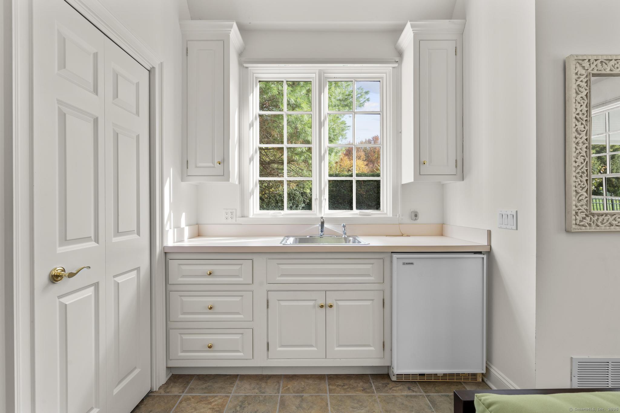 342 Midlock Road Fairfield, CT 06824 - Photo 38 of 40 a kitchen with granite countertop a sink and a window