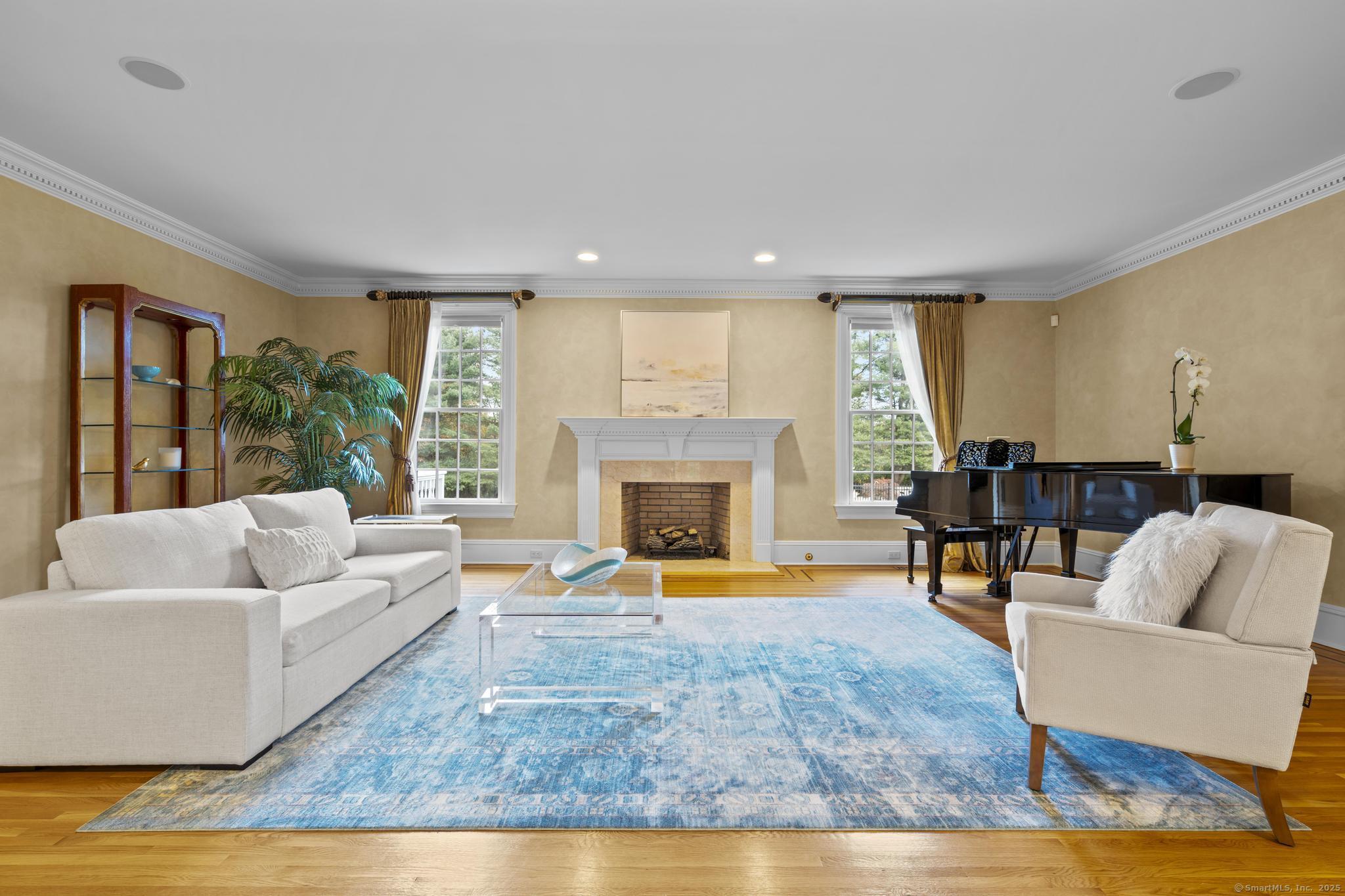 342 Midlock Road Fairfield, CT 06824 - Photo 4 of 40 a living room with furniture and a fireplace