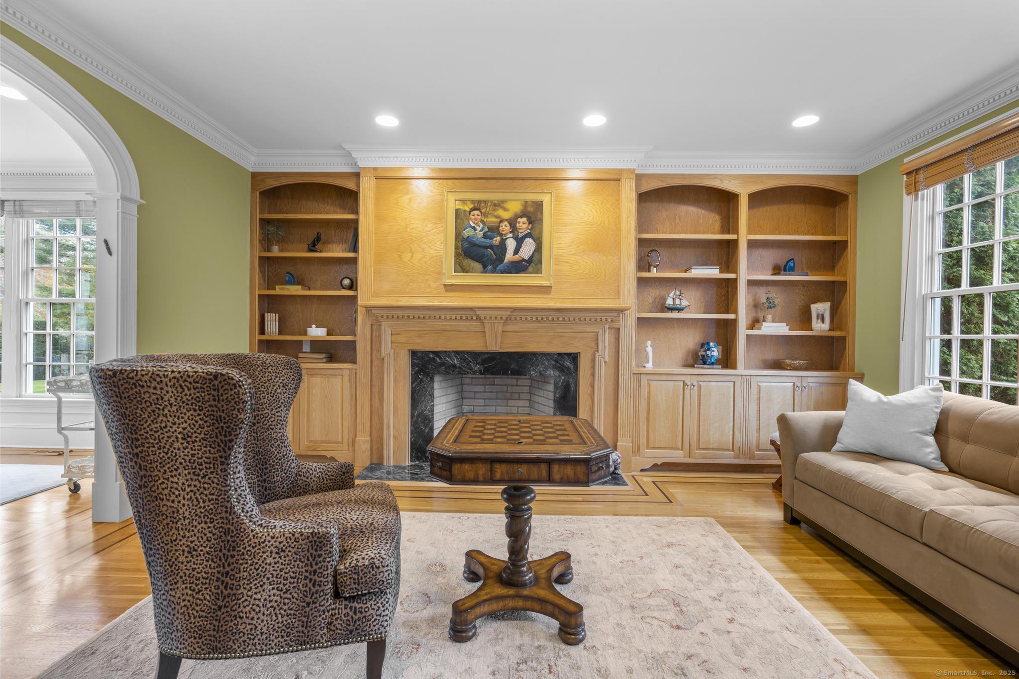 342 Midlock Road Fairfield, CT 06824 - Photo 7 of 40 a living room with furniture and a fireplace