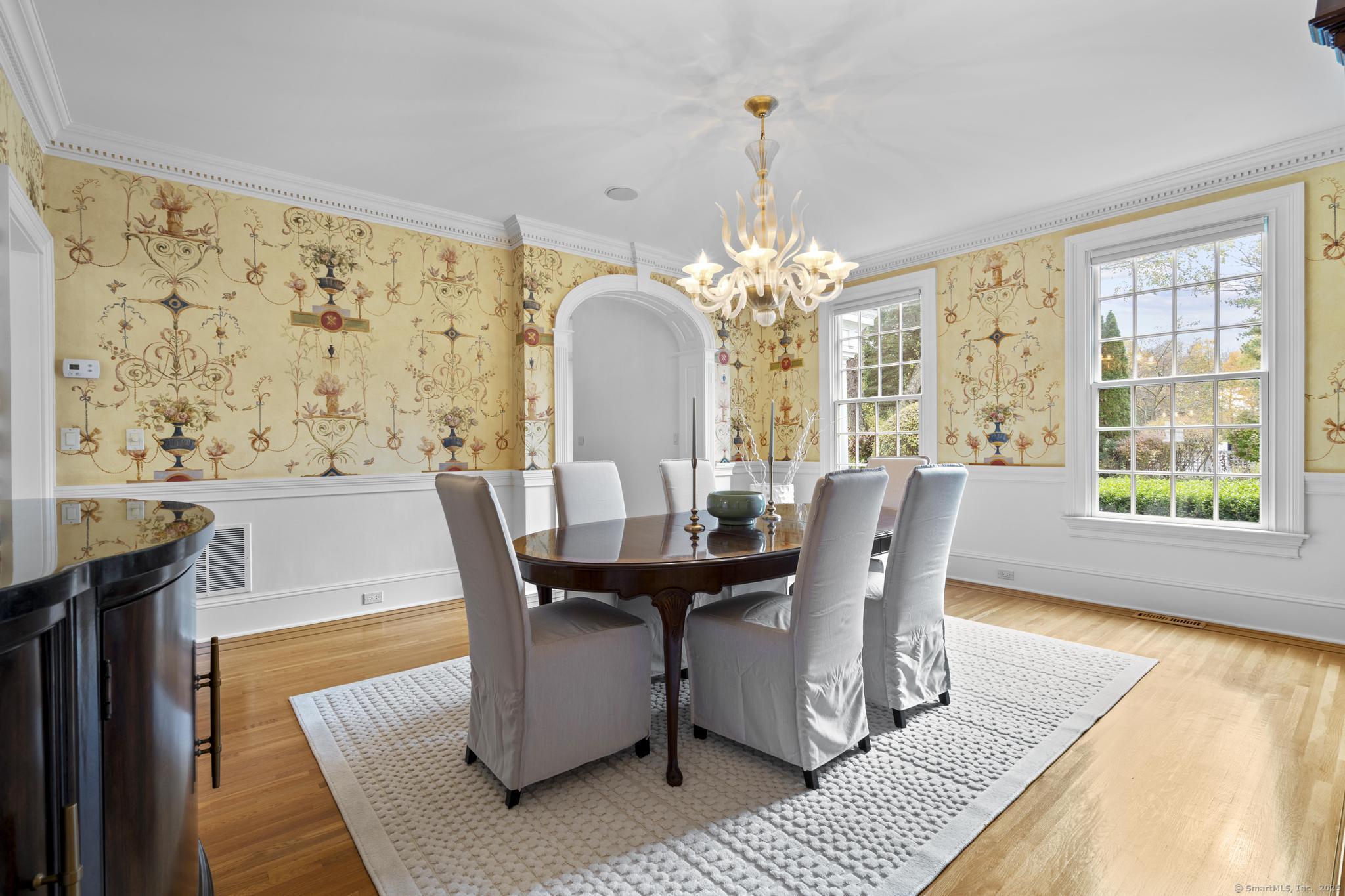 342 Midlock Road Fairfield, CT 06824 - Photo 9 of 40 a dining room with furniture a rug a potted plant and a chandelier