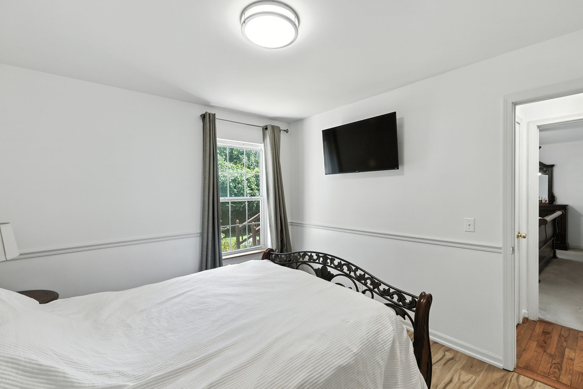 1121 Jacksons Valley Road Hermitage, TN 37076 - Photo 27 of 38 a bedroom with a bed and a flat screen tv