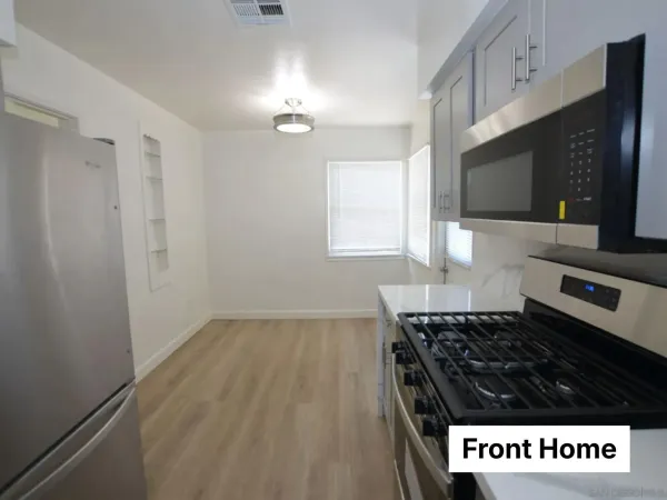 a kitchen with granite countertop a stove and a microwave