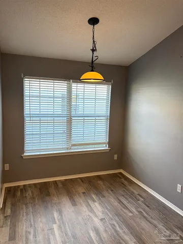 a room with a window and a wooden floor