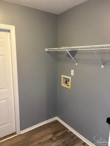 a view of a room with wooden floor