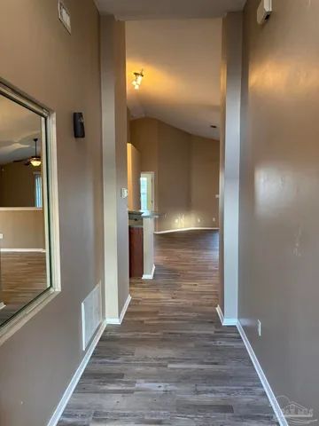 a view of a hallway with wooden floor