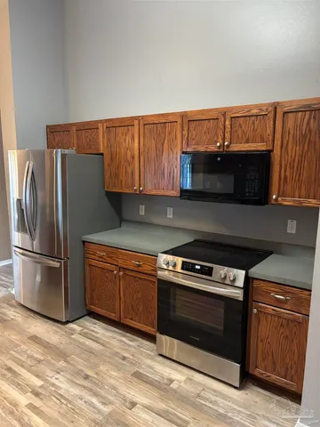 a kitchen with granite countertop a stove and a refrigerator