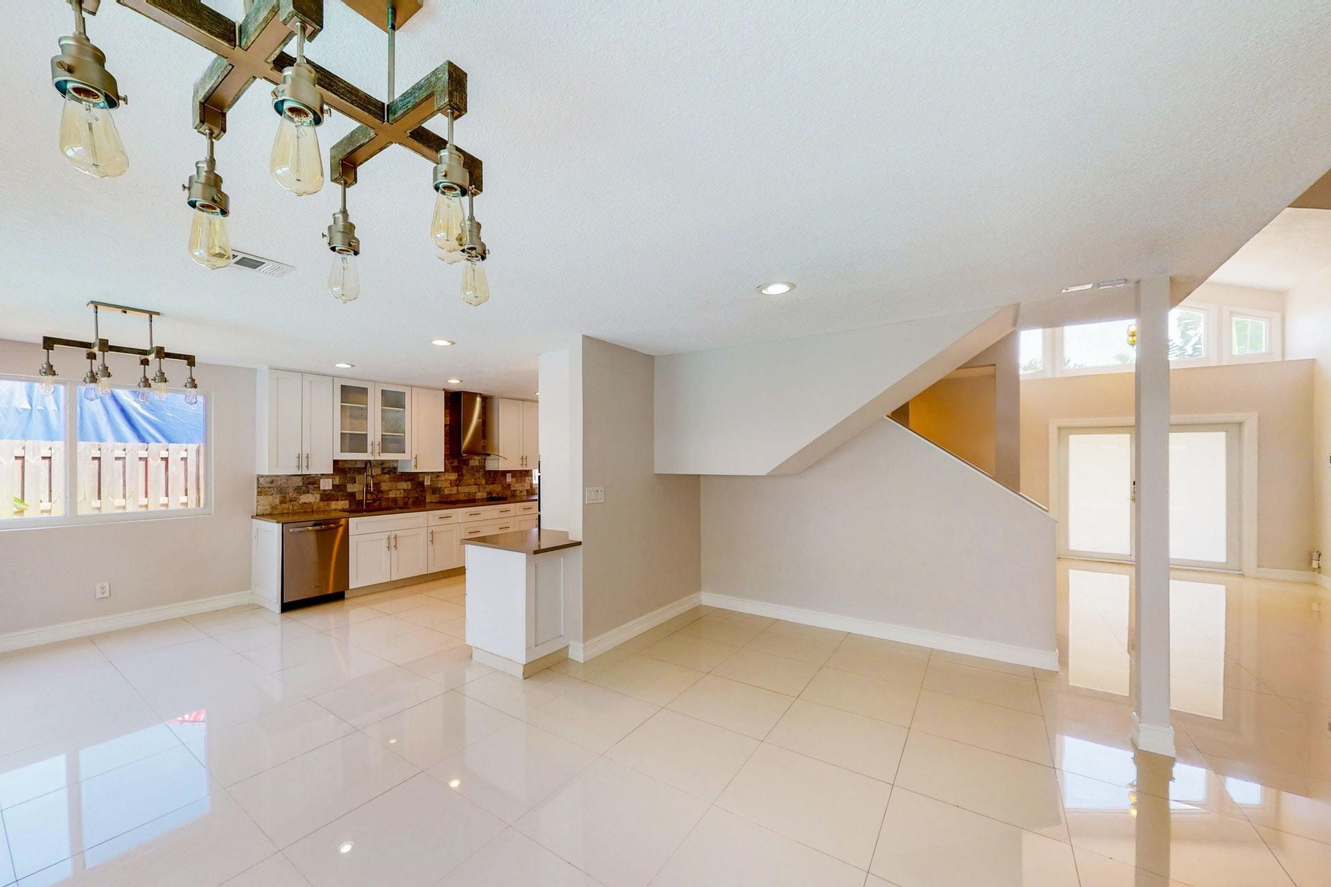 1339 Southwest 3rd Street Boca Raton, FL 33486 - Photo 12 of 56 a kitchen with stainless steel appliances kitchen island granite countertop a sink and cabinets