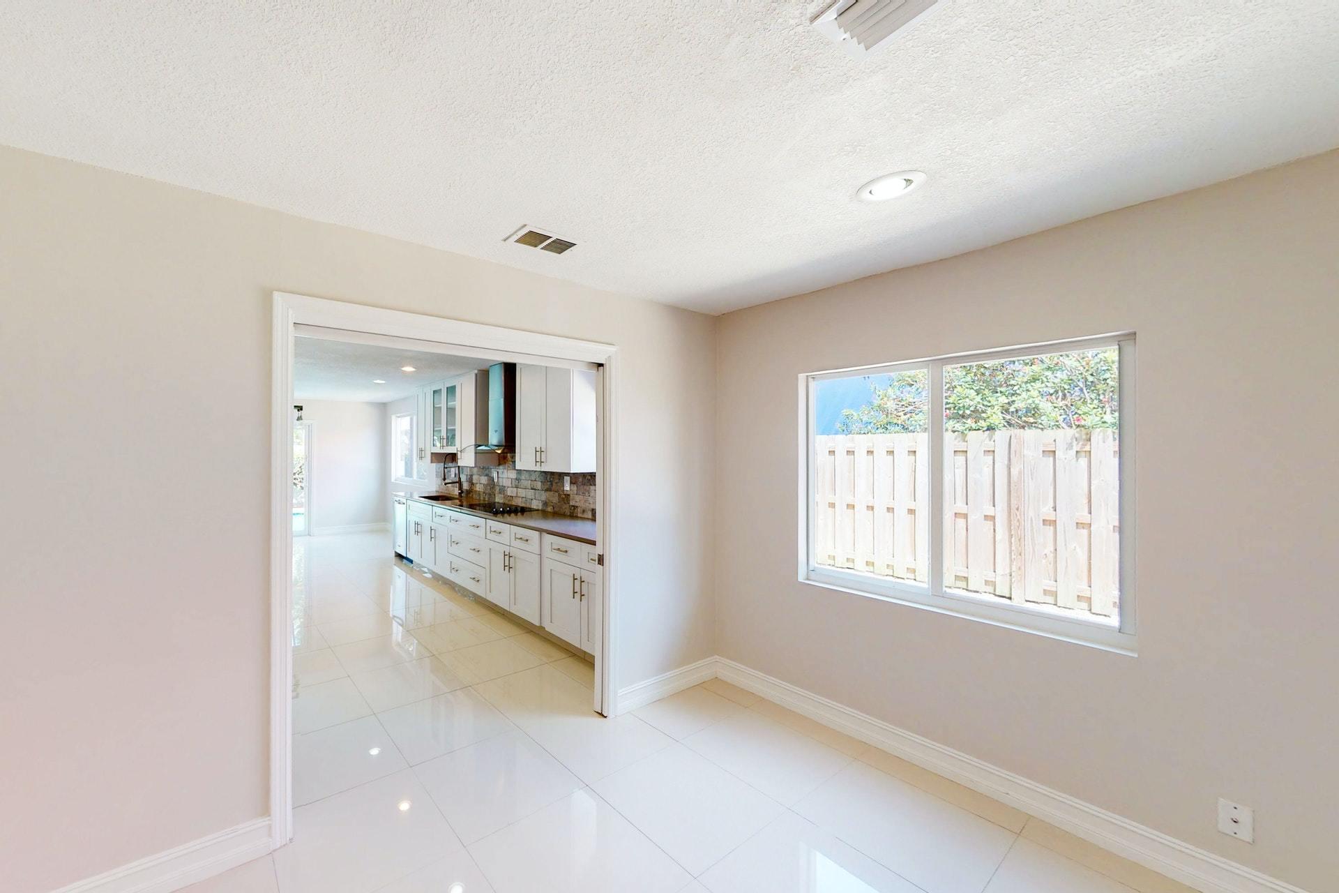 1339 Southwest 3rd Street Boca Raton, FL 33486 - Photo 18 of 56 a kitchen with stainless steel appliances granite countertop a stove and white cabinets