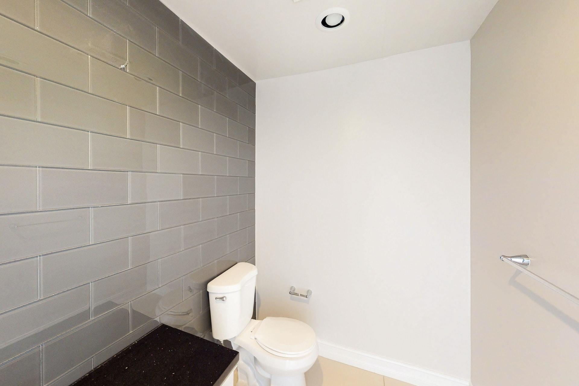 1339 Southwest 3rd Street Boca Raton, FL 33486 - Photo 19 of 56 a white toilet sitting next to a white wall