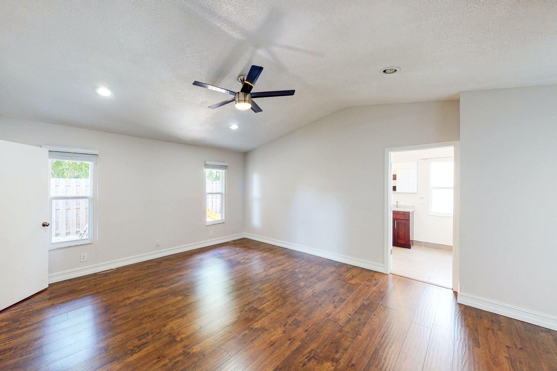 1339 Southwest 3rd Street Boca Raton, FL 33486 - Photo 22 of 56 a view of empty room with wooden floor and fan