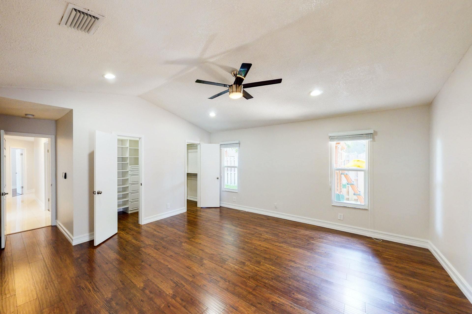 1339 Southwest 3rd Street Boca Raton, FL 33486 - Photo 23 of 56 an empty room with wooden floor and ceiling fan