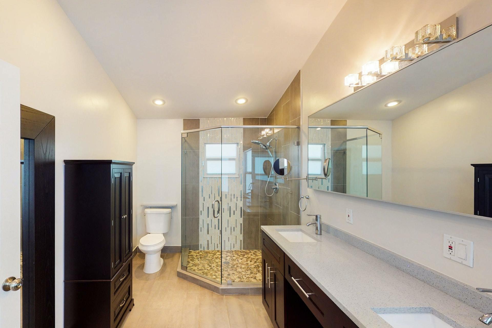 1339 Southwest 3rd Street Boca Raton, FL 33486 - Photo 27 of 56 a bathroom with a double vanity sink toilet and shower