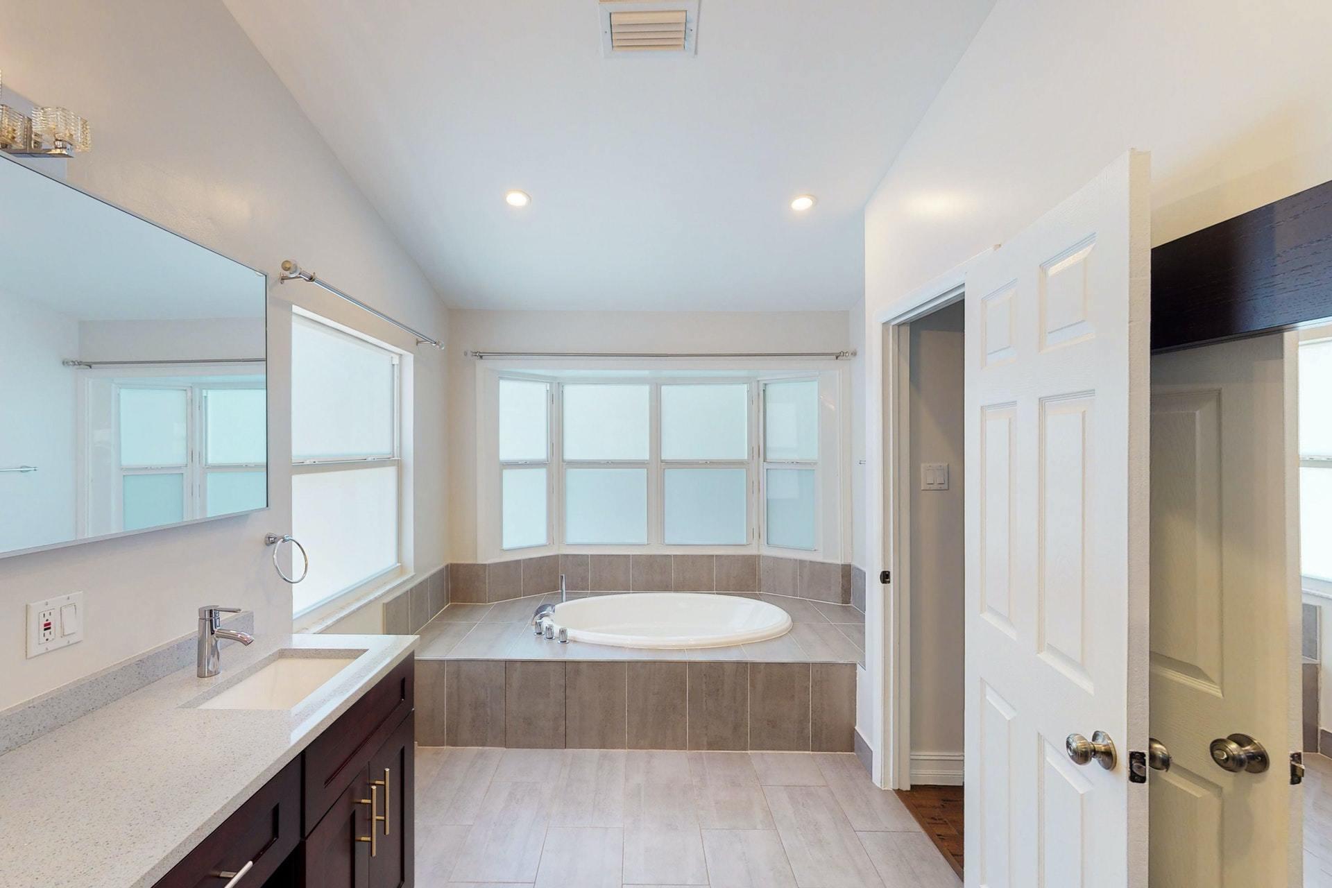 1339 Southwest 3rd Street Boca Raton, FL 33486 - Photo 28 of 56 a bathroom with a tub sink and mirror