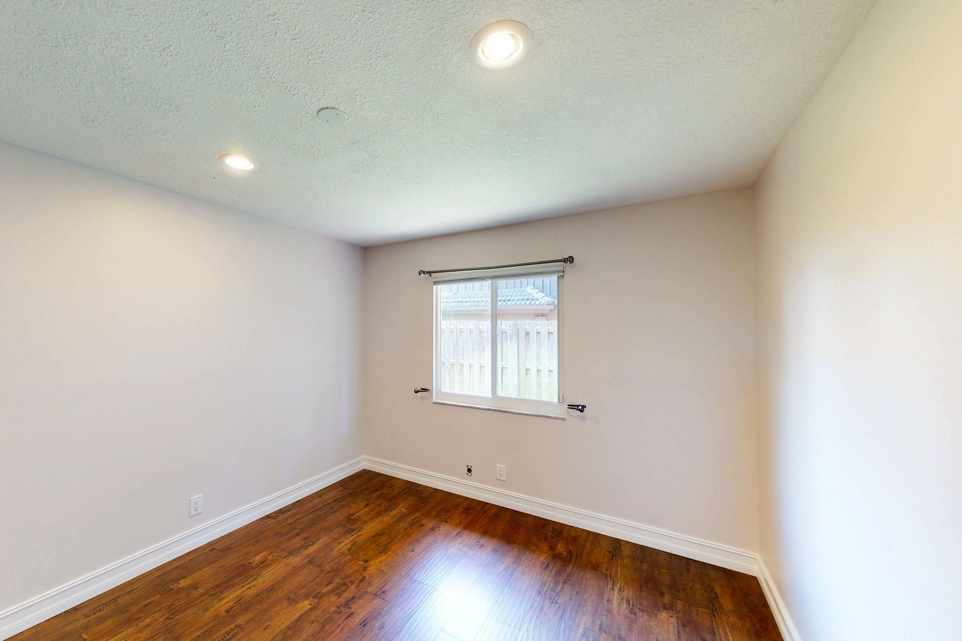 1339 Southwest 3rd Street Boca Raton, FL 33486 - Photo 29 of 56 an empty room with wooden floor and windows