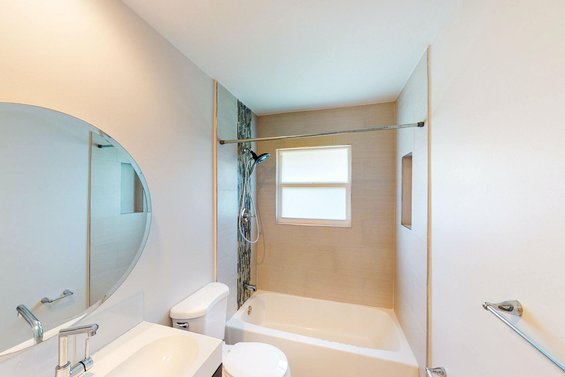 1339 Southwest 3rd Street Boca Raton, FL 33486 - Photo 31 of 56 a bathroom with a toilet and a bathtub