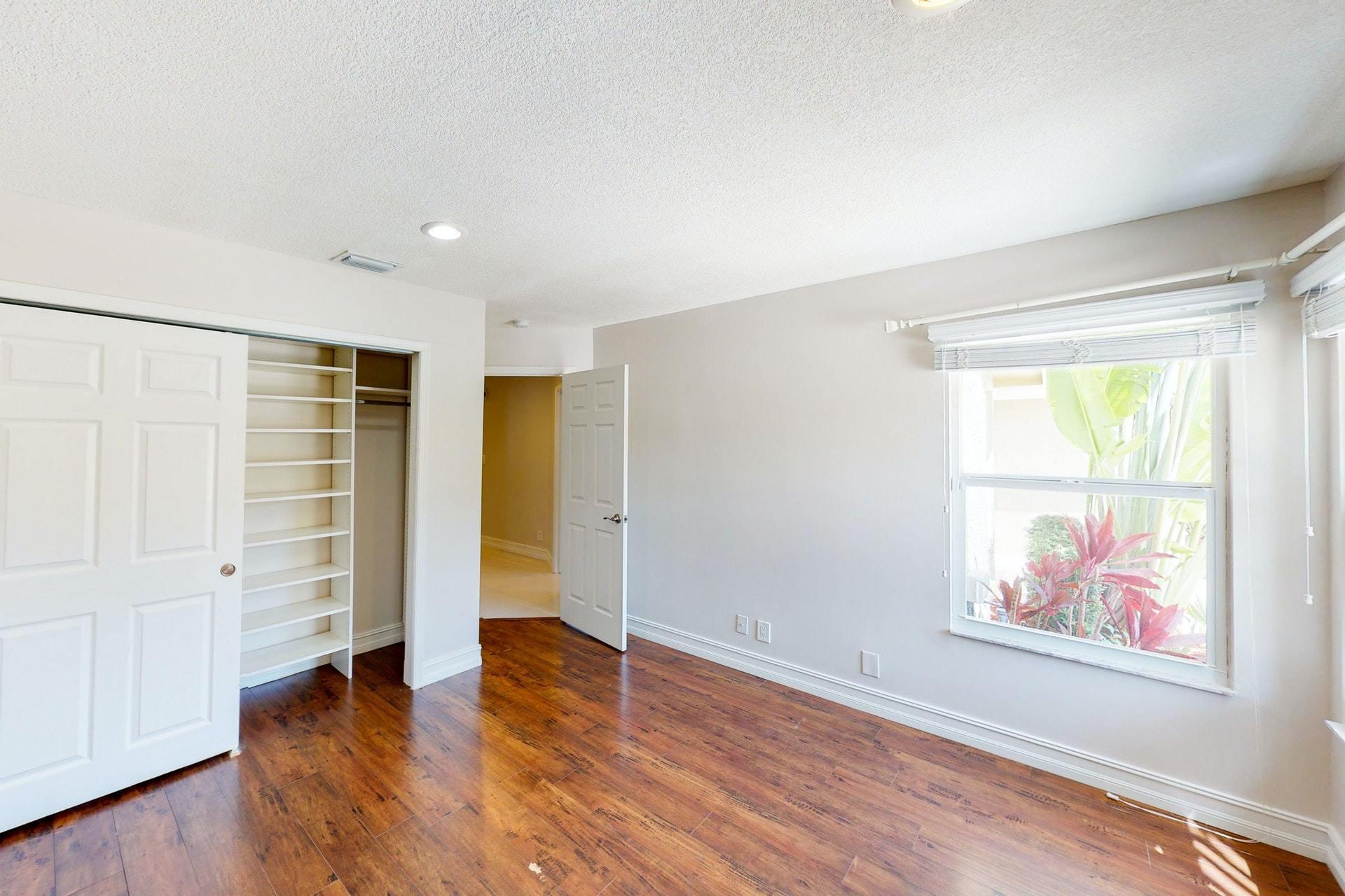 1339 Southwest 3rd Street Boca Raton, FL 33486 - Photo 33 of 56 wooden floor in an empty room with a window